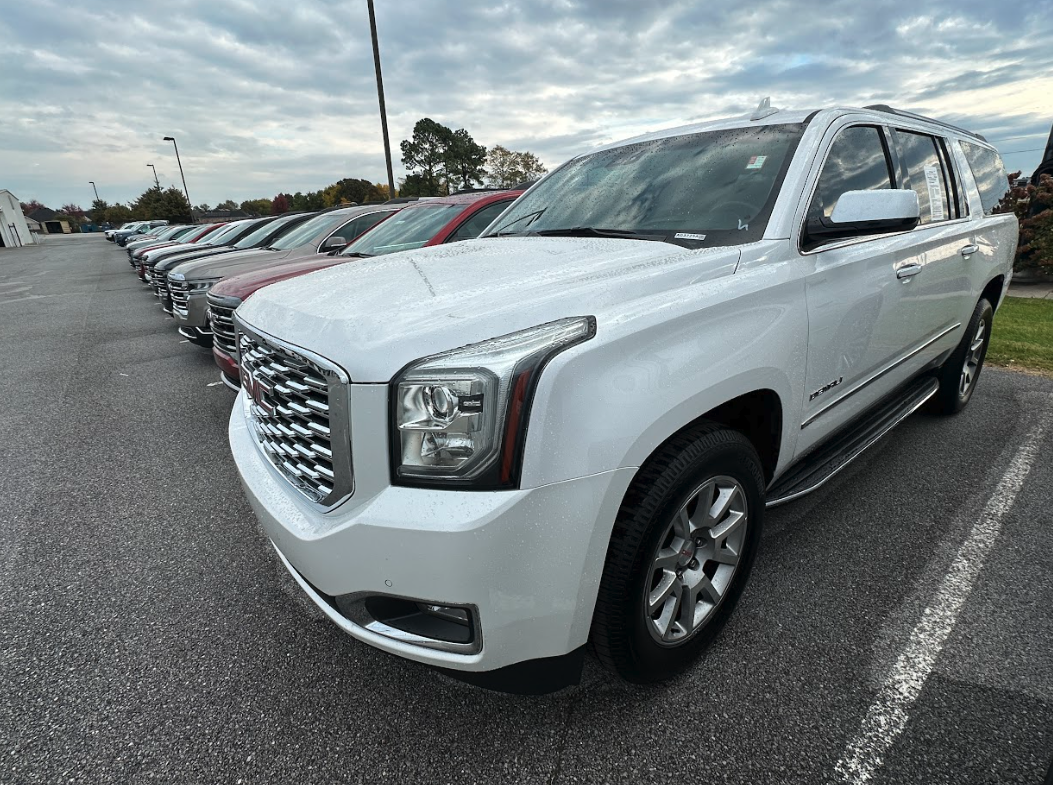White GMC Yukon and other SUVs lined up for lease at Crain Buick GMC in Springdale, Arkansas